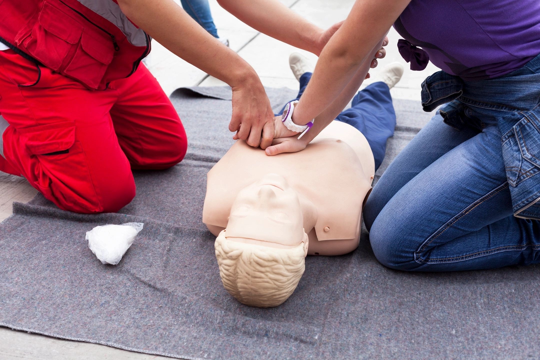 Group CPR training session with mannequin